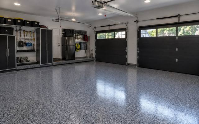 Dark grey flake epoxy floor in a two-car garage in Moncton